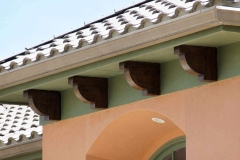 Exterior house painting with green and peach stucco walls in Austin